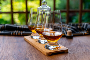 Tasting of Scotch whisky in traditional old British house with wooden windows
