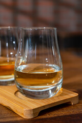 Tasting of Scotch whisky in traditional old house with shadow from British windows