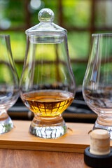 Tasting of Scotch whisky in traditional old British house with wooden windows