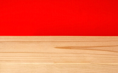 Red wallpaper half and wooden yellow background.