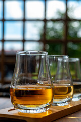 Tasting of Scotch whisky in traditional old British house with wooden windows