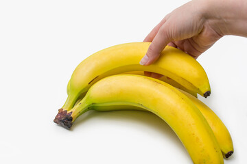 bunch of bananas on a white background. A woman holds a banana