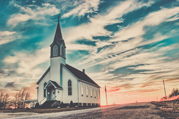 Ellis County, KS, USA - A Lone Wooden Christian Church at Dusk Sunset Skies in the Western Kansas...