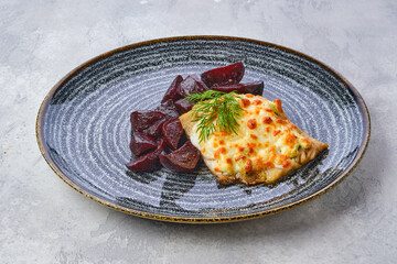 Fried cod fillet with melted cheese topping and roasted beetroot slices