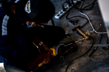 Industrial Worker labourer at the factory welding steel structure