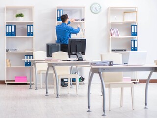 Handsome businessman employee sitting at his desk in office