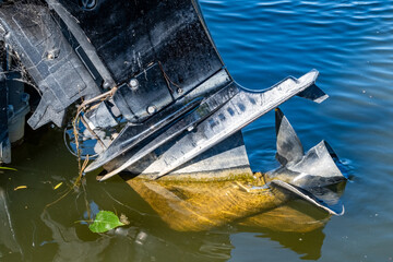 Prop on old outboard motor that's lifted out of the water