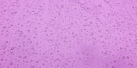 banner of a drop of water on glass in a pink glow. space for text..