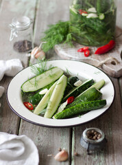 Canned cucumbers in a metal pan on the table