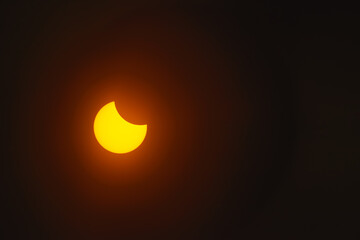 Solar eclipse in dark red glowing sky, amazing scientific background