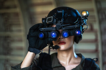 Portrait of female modern army special forces soldier, anti terrorist squad fighter, elite commando warrior using four-eyed night vision goggles in dark background © somchairakin