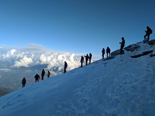 A group hiking down a peak at 3815 metres. - obrazy, fototapety, plakaty