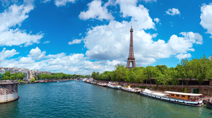 Romantic Paris, panoramic view of riverside with Eiffel tower in Summer. Daylight, bright day, blue...