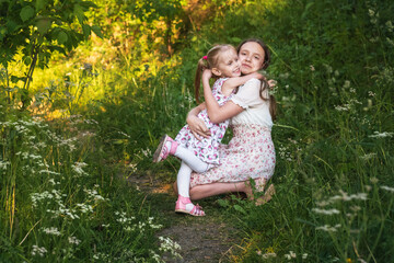 Happy young girls hugging and smiling on nature