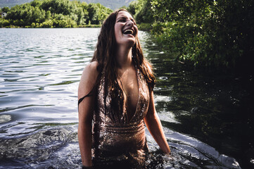 Girl in lake in sparkly dress