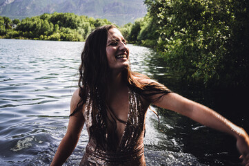 Girl in lake in sparkly dress