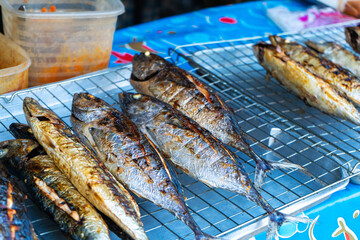 Grilled fish on the counter. Street food. in Asia