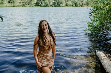 Girl in sparkly dress in lake