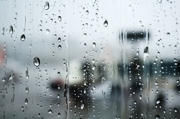 Naklejka na ściany i meble Water drops on window glass in rainy season 