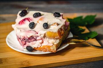 a piece of cake with strawberries and mulberries