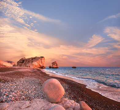 Rock Aphrodite near Petra tou Romiou in Cyprus, Paphos. Panoramic image of famous Cyprus landmark on romantic orange and pink sunset.