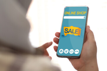 Woman using smart phone, online shopping displayed on the screen, big sale, buying on internet store