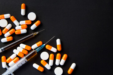 Drug abuse Concept. Syringe and pills preparation and prepared the heroin on the black table. Stop the use of drugs.Opioid epidemic .