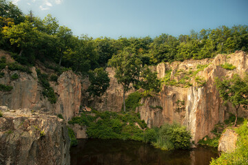 Flooded ancient stone quarry in Hungary near Sarospatak. Megyer-hegyi tengerszem. Small lake at the top of a hill. View from the top. Fantastic nature attraction in Tokaj area.