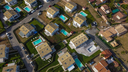 Aerial view of the Villa in Campofelice di Roccella in Sicily, under a beautiful sunny sky, with swimming pools and trees.