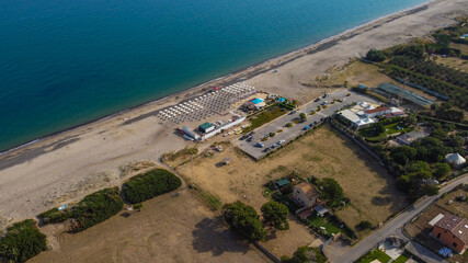 Aerial view of the Villa in Campofelice di Roccella in Sicily, under a beautiful sunny sky, with swimming pools and trees.