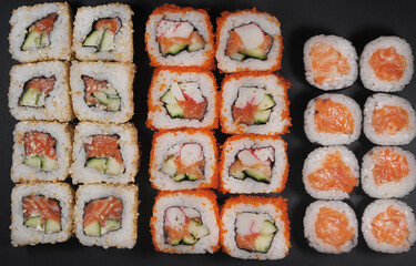Japanese rolls on black stone background.