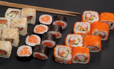 Japanese rolls on black stone background.