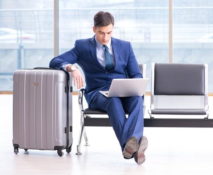 Businessman waiting at the airport for his plane in business cla