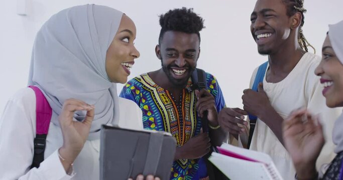 group of happy african students having conversation and team meeting working together on homework girls wearing traditional sudan muslim hijab fashion