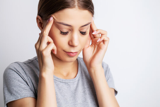 Head pain, exhausted young woman has suffering from unbearable headache