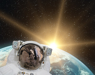 Astronaut and sunrise. The elements of this image furnished by NASA.