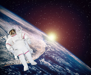 Space and sunrise. Astronaut in cosmos. The elements of this image furnished by NASA.
