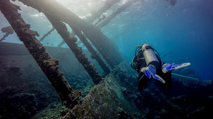 The diver flies over the huge deck of the sunken ship. Port Sudan (Sudan)