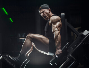 bodybuilder fitness man pumping up legs muscles