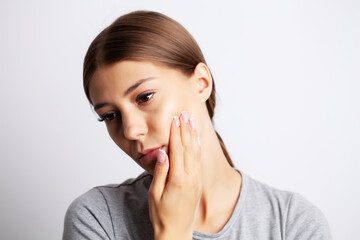 Fototapeta premium Exhausted young woman suffering from severe toothache