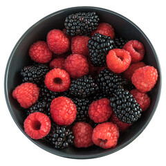 Blackberries and raspberries in a black bowl. White background.