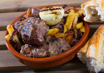 Cooked braised  tenderloin of beef  with potatoes and onions at clay pot