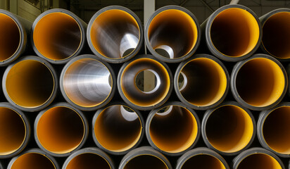 PVC pipes stacked in warehouse. Warehouse of finished plastic pipes industrial outdoors storage site.