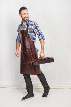 A Man In A Leather Kitchen Apron