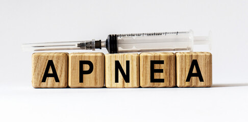 Text APNEA made from wooden cubes. White background