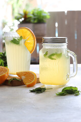 Cold and refreshing infused water with lemons, oranges, and mint leaves. Summer healthy drink.