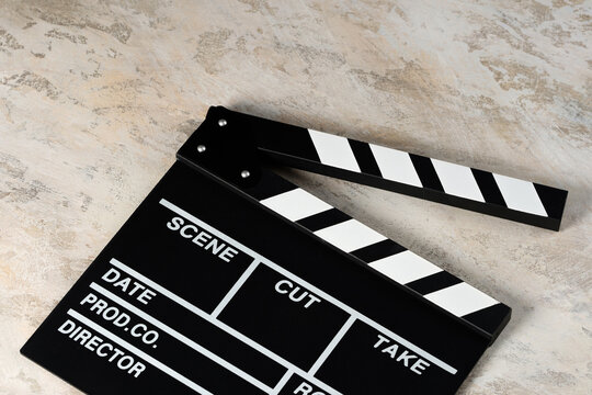 Clapper board with popcorn. Movie concept. Clapperboard on a textural background. Close-up. Copy space.