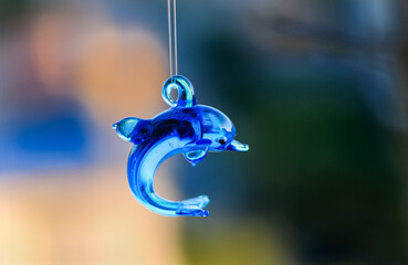 Porcelain dolphin on a string