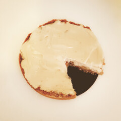 Cutaway cheesecake with cutaway on a black plate, isolated on belm background. The concept of...