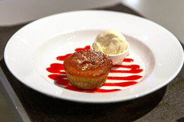 Cupcake muffin and ice cream sundae with jam on white plate